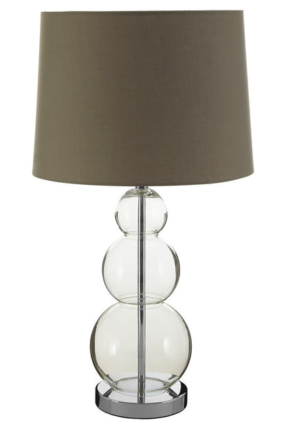 Table lamp with clear glass base and dark brown shade on a white background