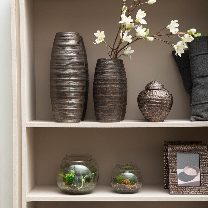 Decorative items including vases, a framed picture, and candles on a shelf.