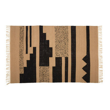 Beige and black geometric patterned rug with fringes on a white background