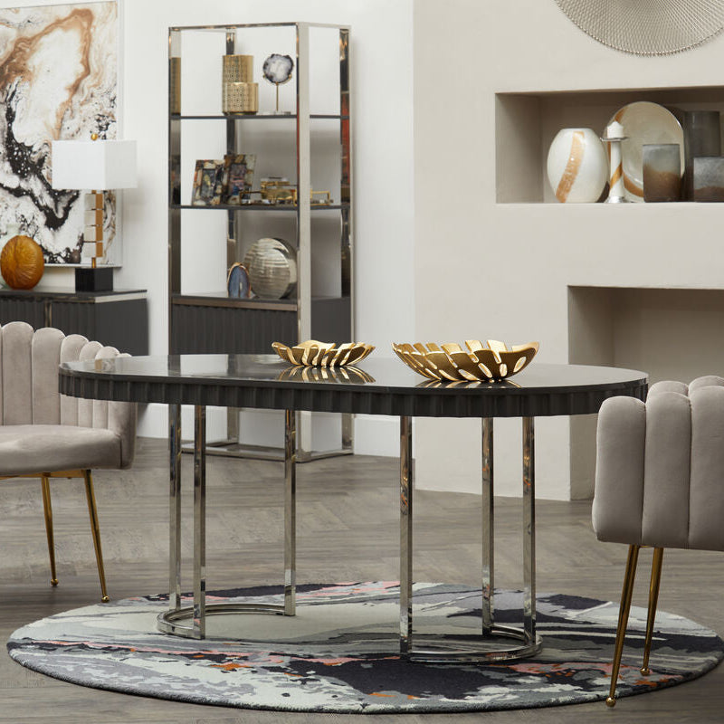 Modern dining room with a round table and chairs in a stylish interior setting.