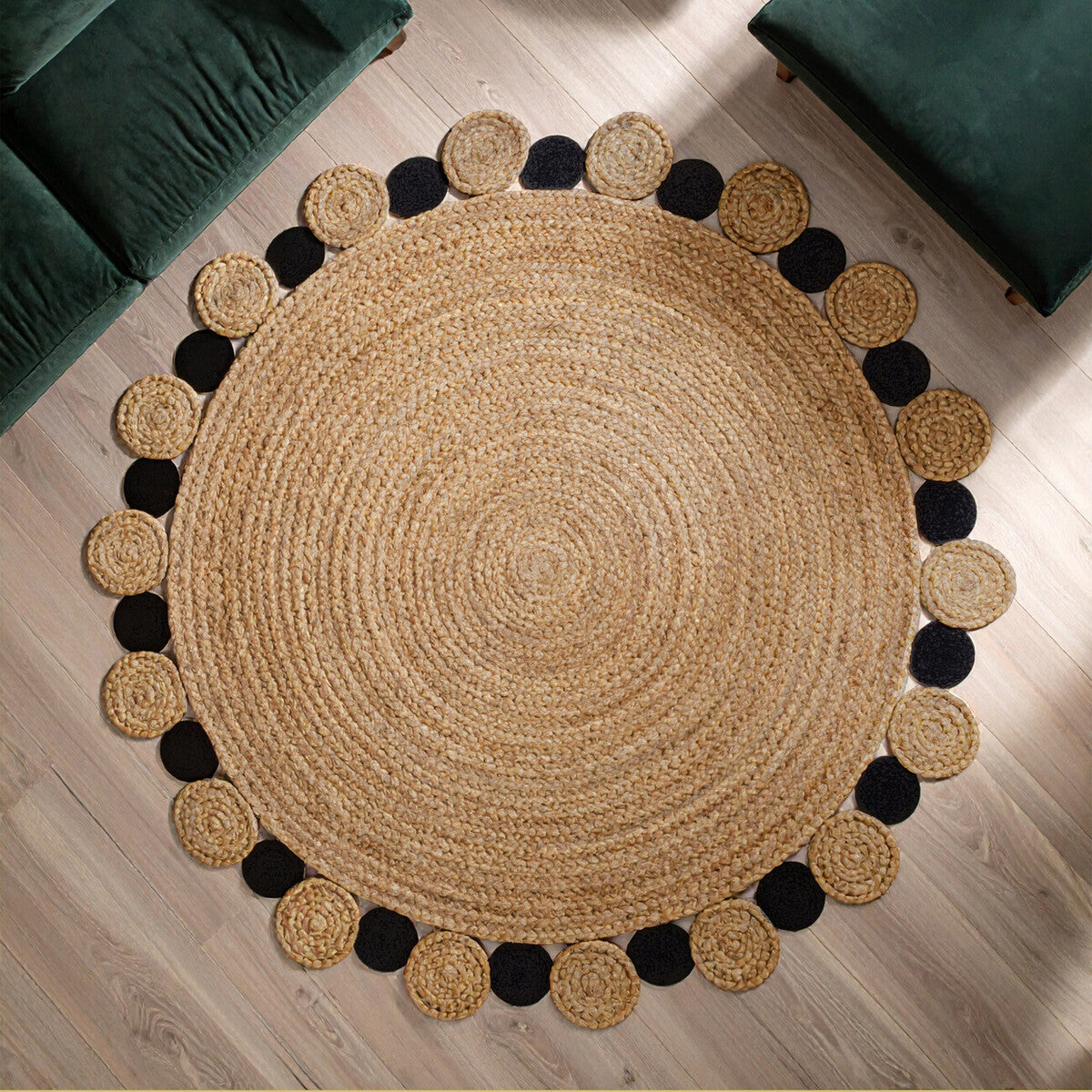 Round jute rug with black pom-pom trim on a wooden floor