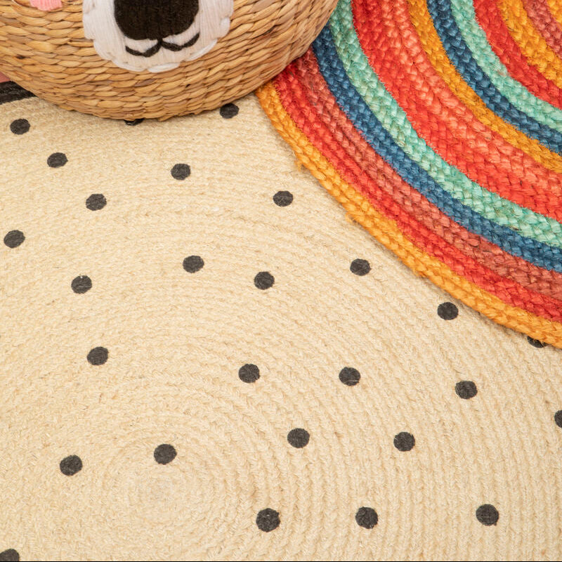 Woven basket with bear face design on a polka dot surface with a colorful rug in the background