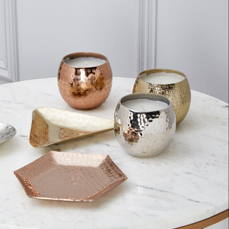 Decorative ceramic items on a marble table with a neutral background