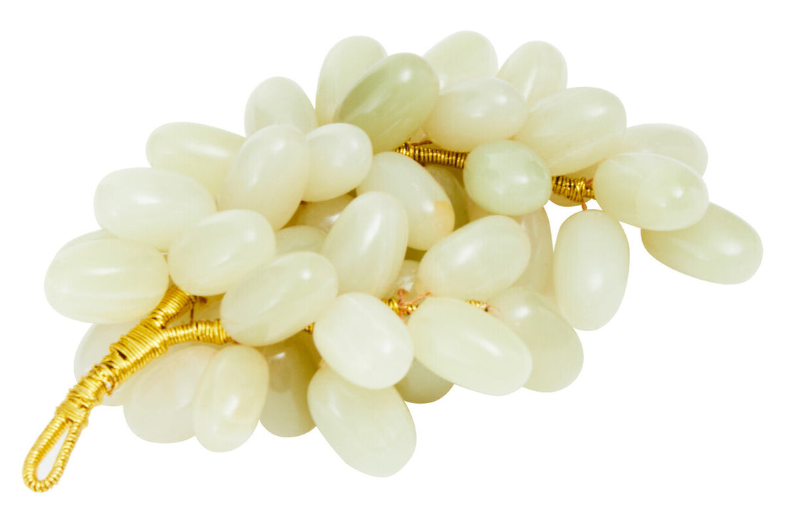 White stone bracelet with gold accents on a white background
