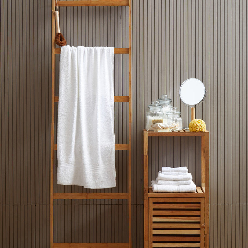 Wooden ladder with a white towel and small wooden shelf against a striped wall.