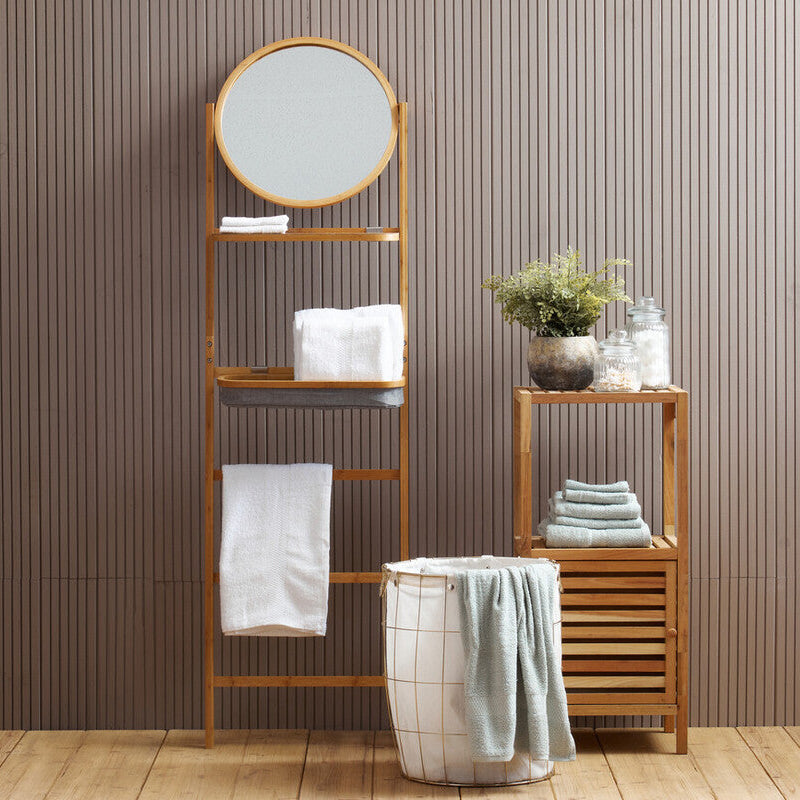 Bathroom setup with wooden shelves, mirror, and towels against a striped wall.