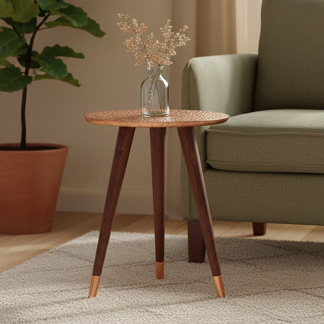 Small wooden side table with a vase of flowers in a living room setting.