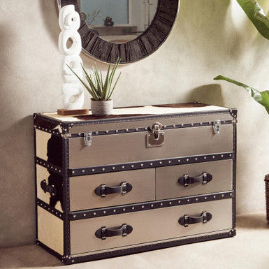 Beige dresser with black accents in a room setting with a mirror and decor items.