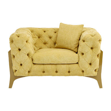 Yellow tufted loveseat with a pillow on a white background