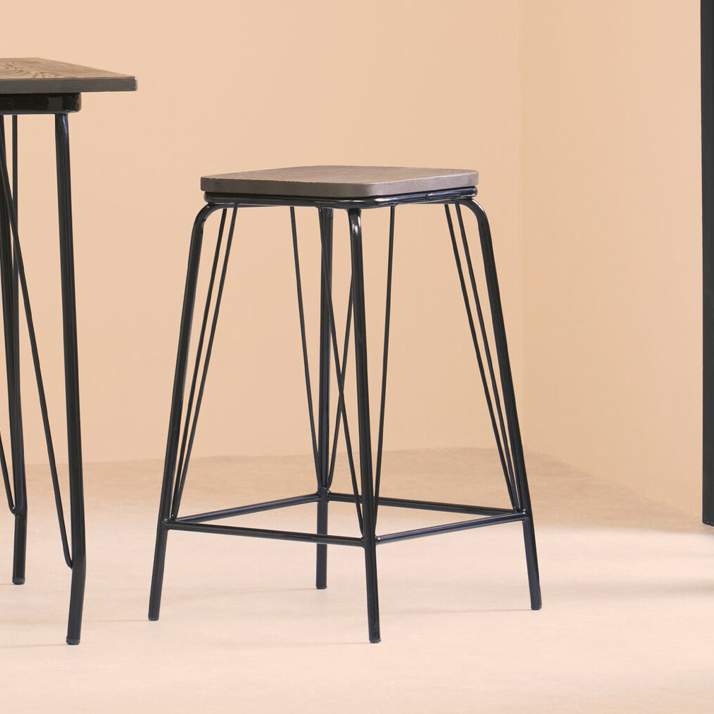 Bar stool with metal frame and wooden seat on a beige background
