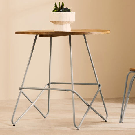 Small wooden table with a chair against a beige wall.