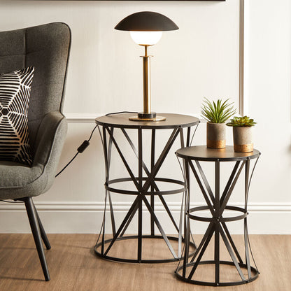 Modern living room with a gray armchair, side table, and decorative elements.