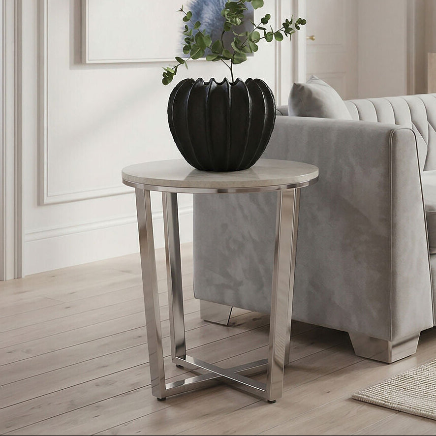 Modern living room with a gray sofa, side table, and decorative plant.
