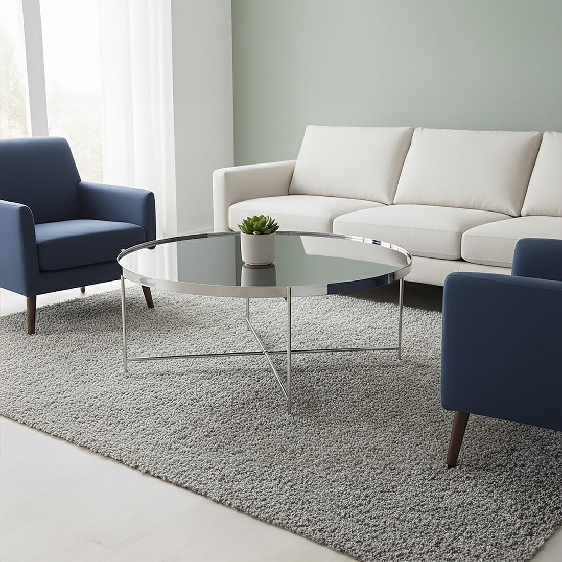 Modern living room with a white sofa, blue armchair, and glass coffee table.