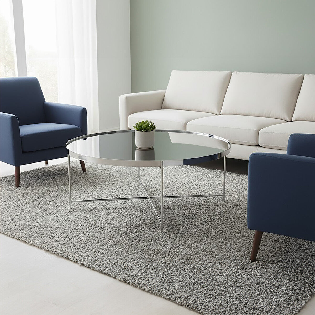 Modern living room with a white sofa, blue armchair, and glass coffee table.