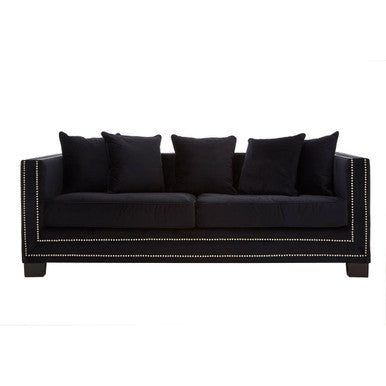Black sofa with decorative nailhead trim on a white background