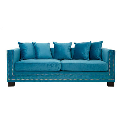 Blue sofa with decorative pillows on a white background