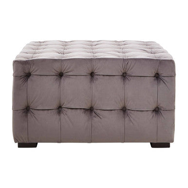 Gray tufted ottoman on a white background