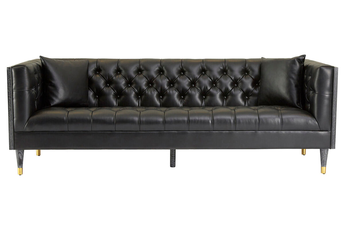 Black leather sofa with tufted backrest on a white background