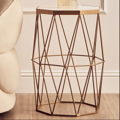 Modern living room with a beige armchair, geometric side table, and decorative mirror.