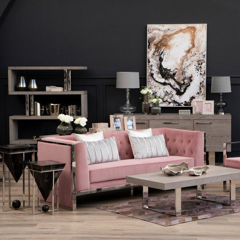 Modern living room with pink sofa, coffee table, and decorative items.