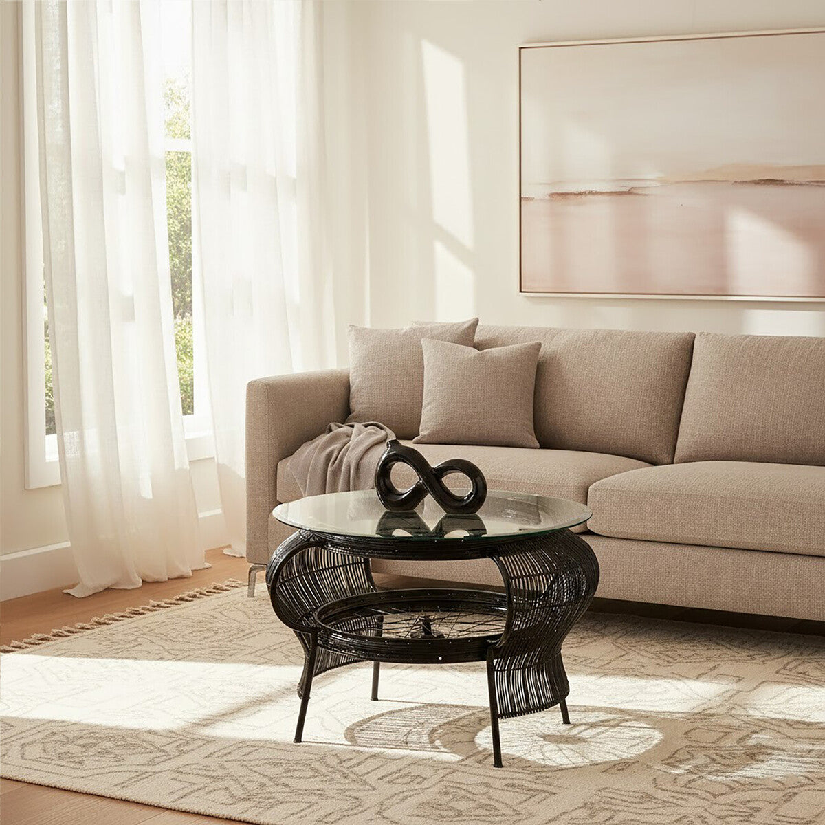 Living room with beige sofa, black wire coffee table, and decorative items.