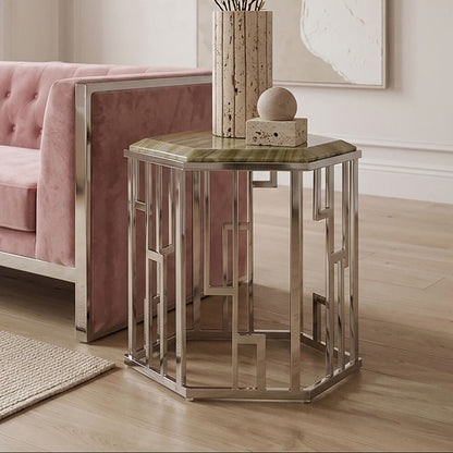 Modern living room with a pink sofa and decorative side table.