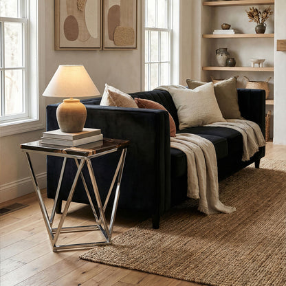 Living room with a black sofa, side table, and decorative items.