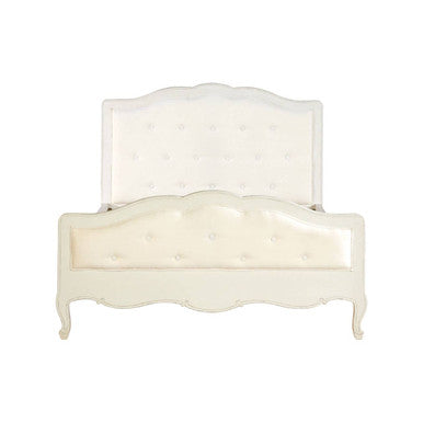 White upholstered bed with a decorative headboard on a white background