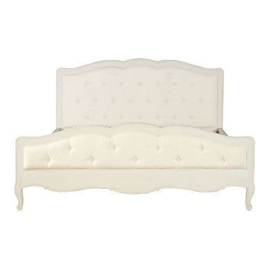 White upholstered bed with tufted design on a white background