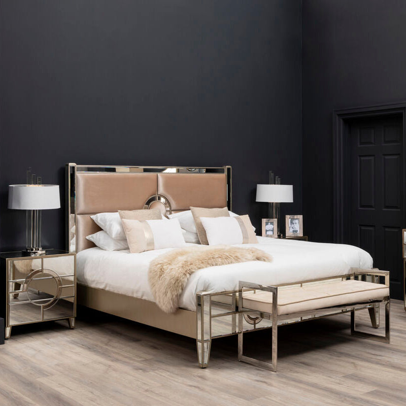 Bedroom with a bed, nightstands, and lamps against a dark wall.