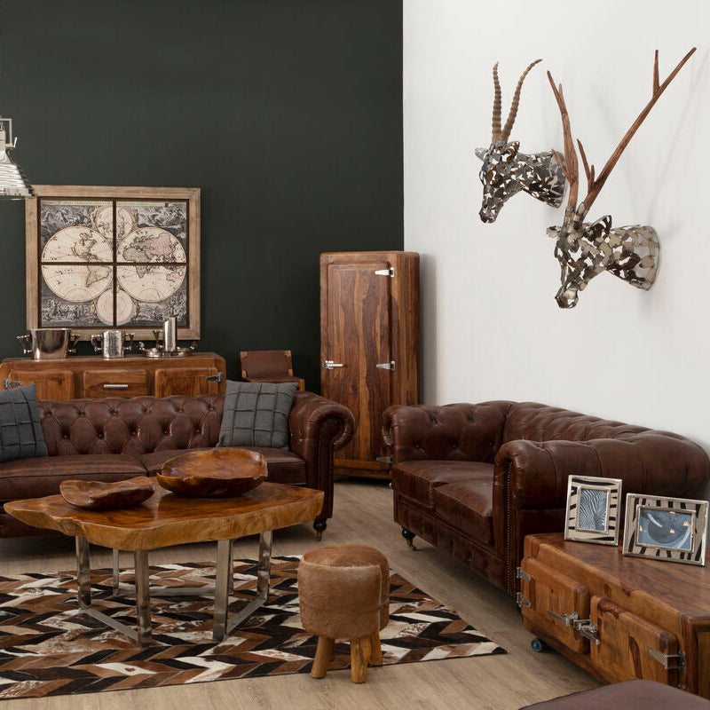 Living room with brown leather sofas, wooden coffee table, and decorative items.