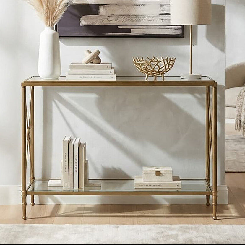 Decorative console table with books, a lamp, and decorative items in a living room setting.