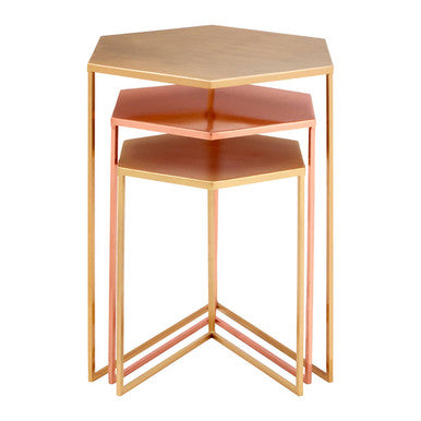 Set of three hexagonal side tables with a rose gold finish on a white background