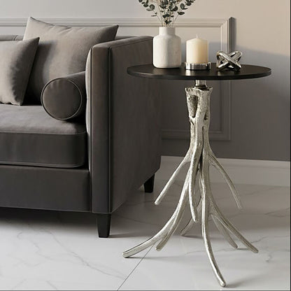 Modern living room with a gray sofa, decorative side table, and wall art.