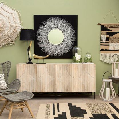 Modern interior with a sideboard, chairs, and decorative items against a green wall.