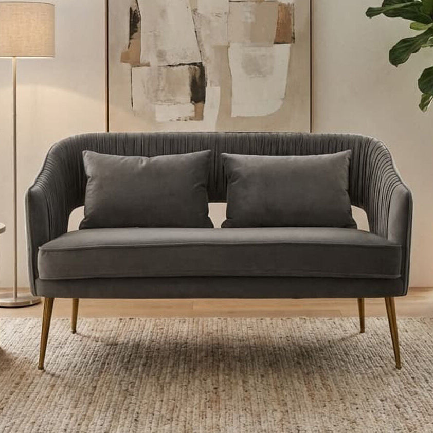 Gray sofa in a living room with abstract art, lamp, and plant.