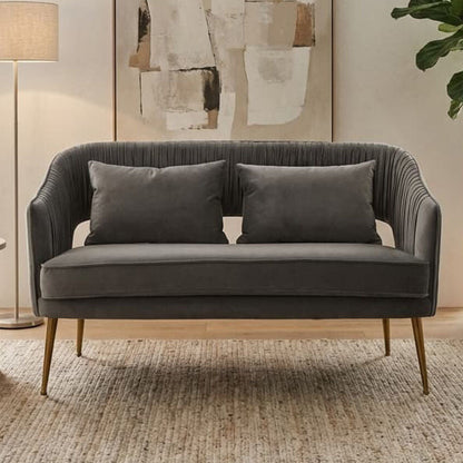 Gray sofa in a living room with abstract art, lamp, and plant.