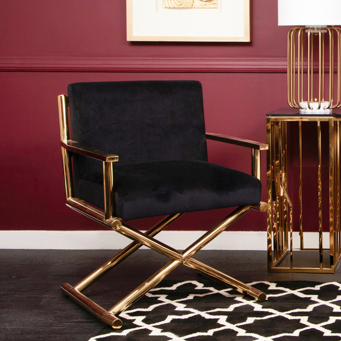 Black chair with gold frame against a red wall