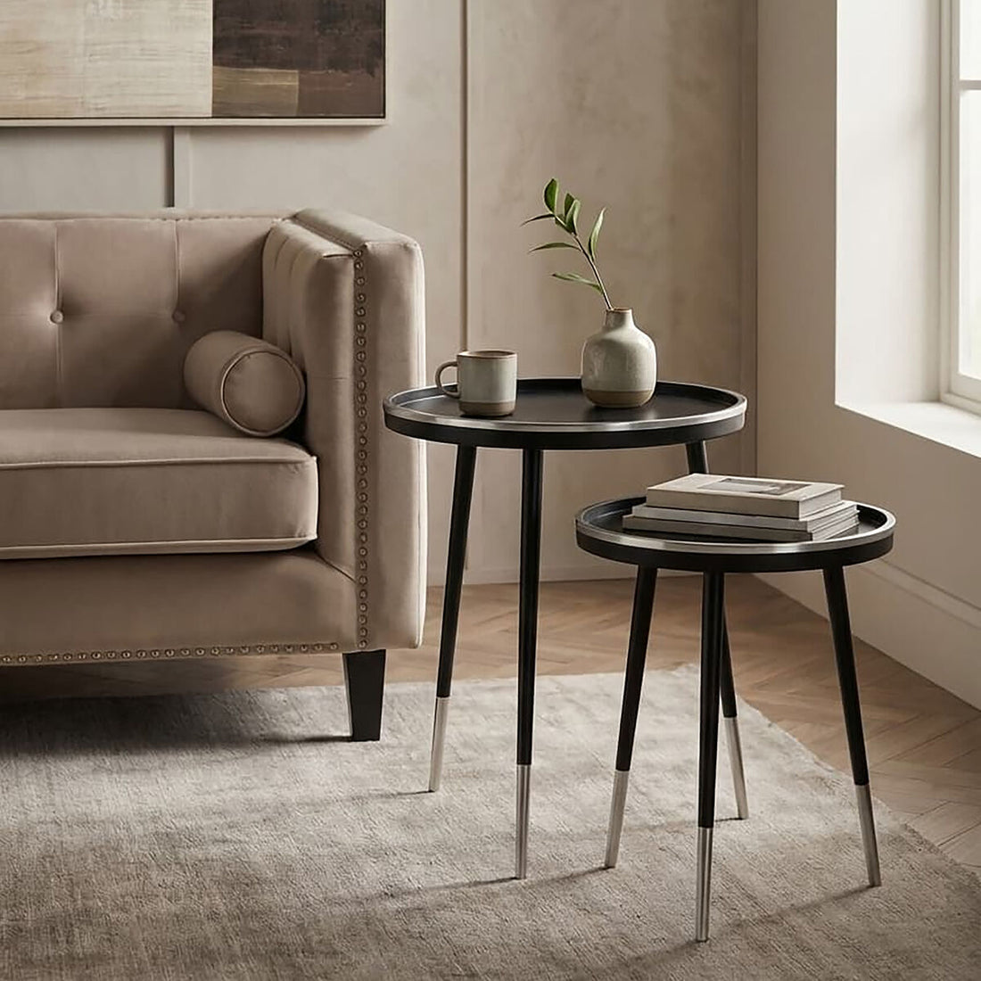 Modern living room with a beige sofa, side tables, and decor items.