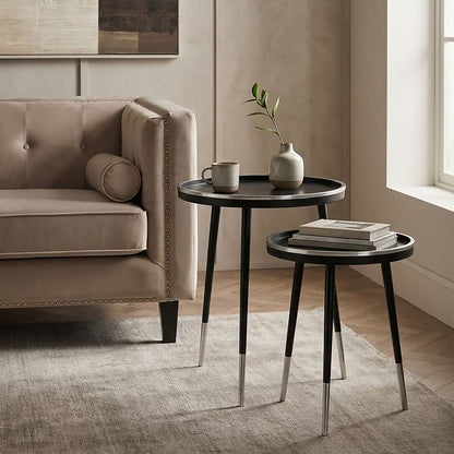 Modern living room with a beige sofa, side tables, and decor items.
