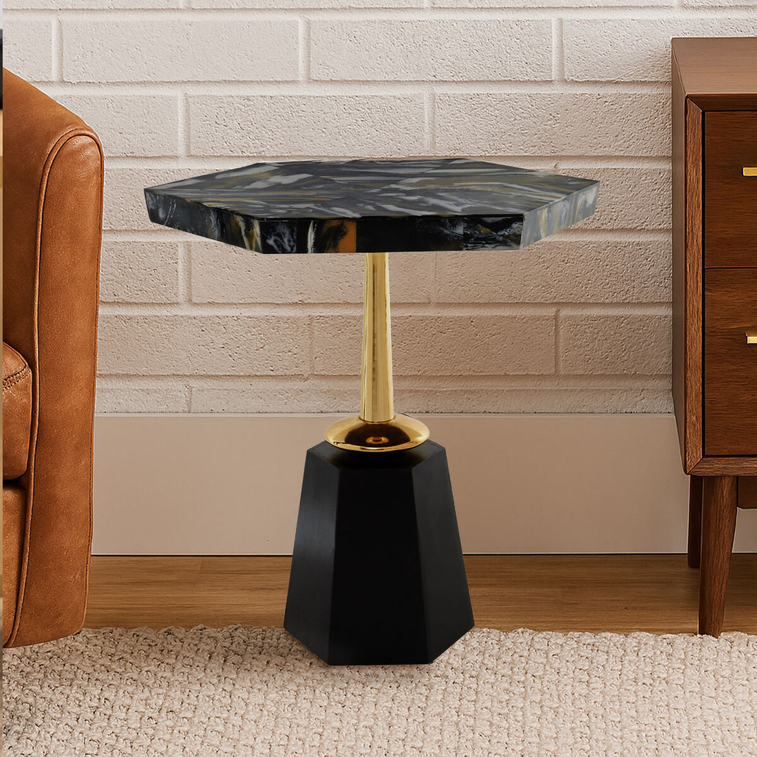 Small side table with black marble top and gold accent in a room setting.