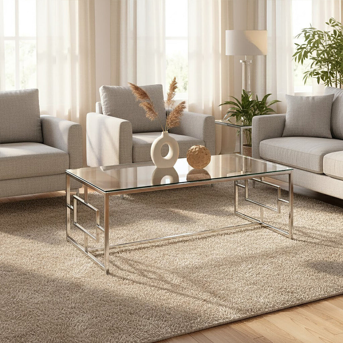 Modern living room with gray sofa, armchair, and glass coffee table.