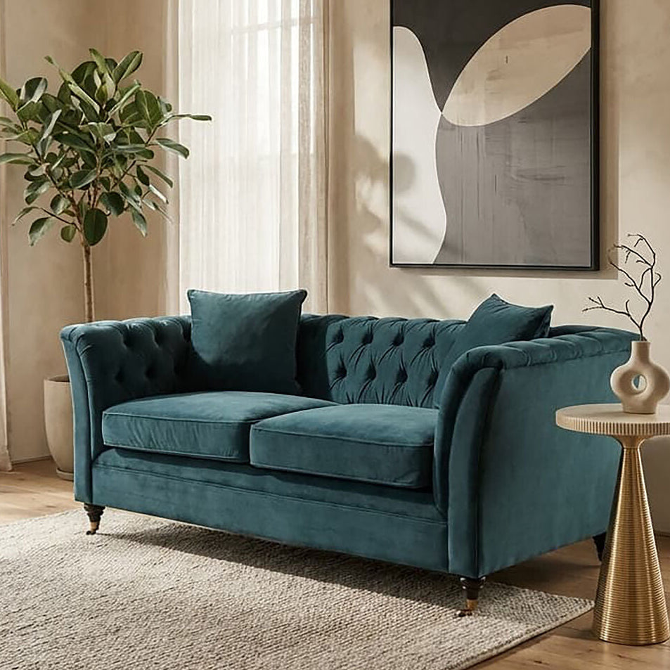 Teal sofa in a living room with abstract art and plants