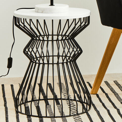 Black chair and side table with a lamp in a room setting