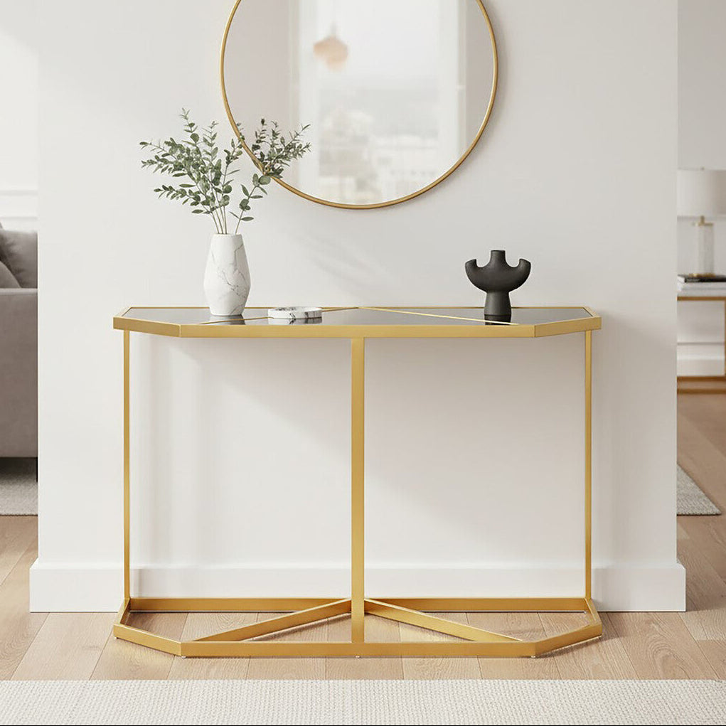 Modern console table with gold frame and white surface in a living room setting.