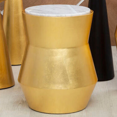 Set of gold and black stools with white tops against a tiled wall.