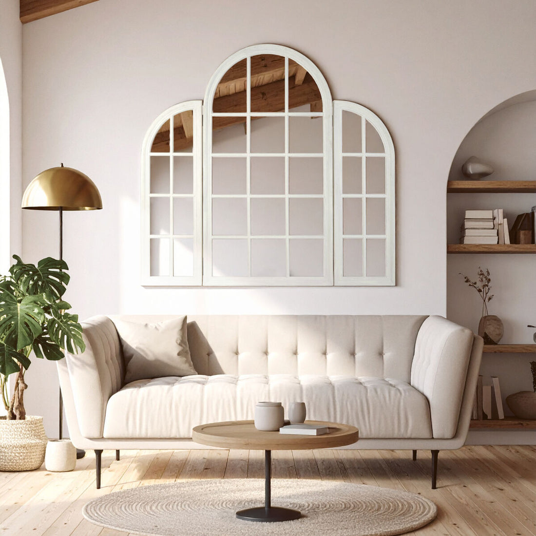 Modern living room with a large decorative mirror, white sofa, and wooden coffee table.