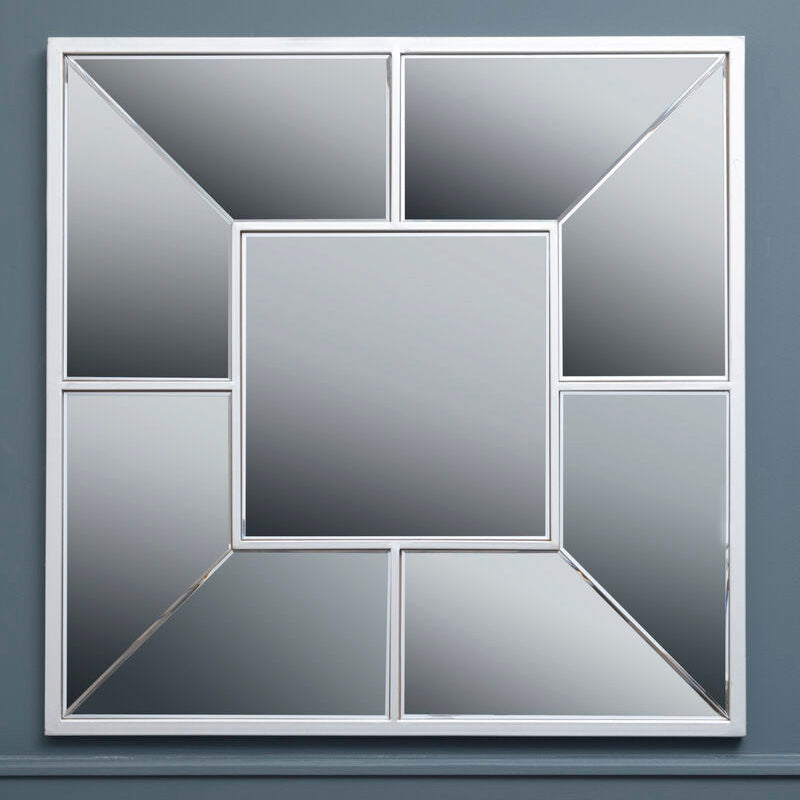Decorative mirror with geometric design on a gray wall