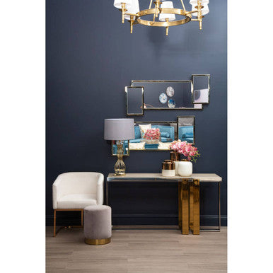 Modern interior design with a console table, chair, and decorative elements against a dark blue wall.